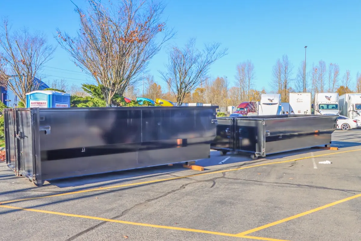 Professional dumpster rental service with roll-off container on residential driveway in Lake Shore